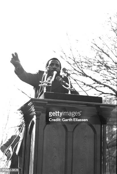 American comedian and activist Dick Gregory speaks from a podium during the Moratorium March On Washington to protest the war in Vietnam, Washington...