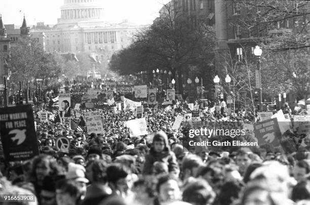 View of demonstrators, many with signs, banners, or flags, on Pennsylvania Avenue during the Moratorium March On Washington to protest the war in...