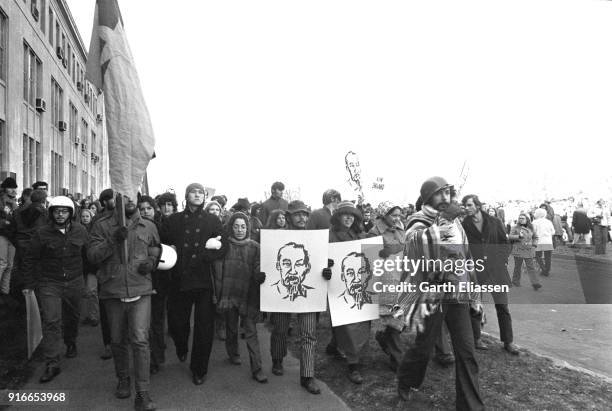 View of demonstrators, several signs and Viet Cong flags, during the Moratorium March On Washington to protest the war in Vietnam, Washington DC,...