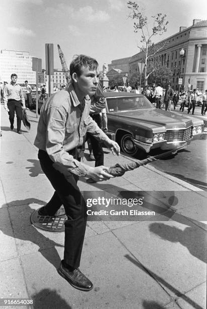 During a nationwide student strike , an unidentified neo-Nazi counter-protestor threatens demonstrators with a broken flagpole on Pennsylvania...
