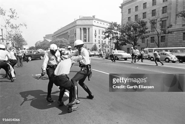 During a nationwide student strike , police officers arrest a neo-Nazi counter-protestor on Pennsylvania Avenue, Washington DC, May 9, 1970. Visible...