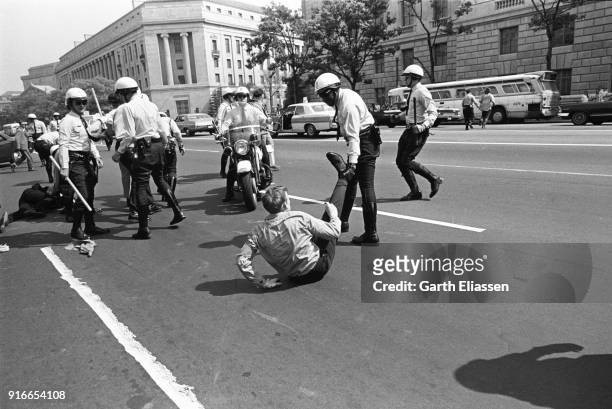During a nationwide student strike , a police officer arrests a neo-Nazi counter-protestor on Pennsylvania Avenue, Washington DC, May 9, 1970....