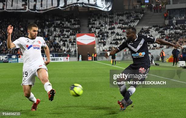 Bordeaux's French defender Maxime Poundje vies for the ball with Amiens' Moroccan defender Oualid El-Hajjam during the French L1 football match...