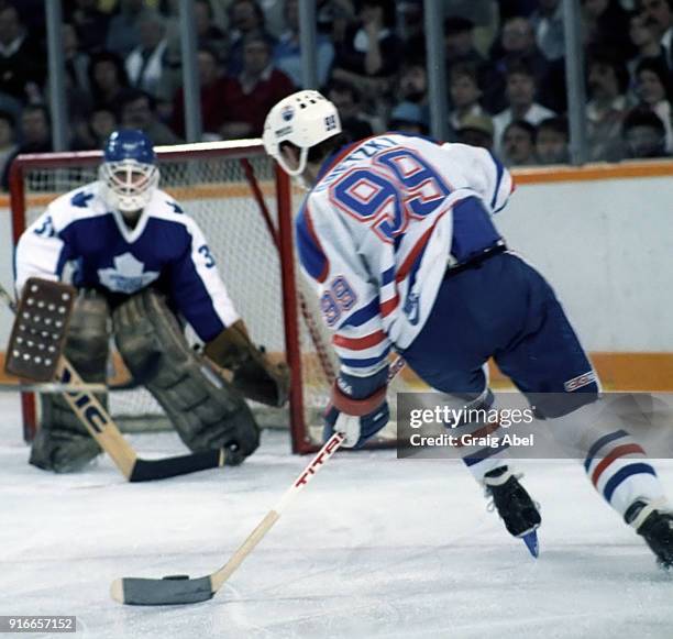 Wayne Gretzky of the Edmonton Oilers skates against Ken Wregget of the Toronto Maple Leafs during NHL game action on February 19, 1986 at Northlands...