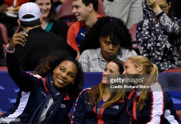 Serena Williams of Team USA, bottom left, takes a selfie photo with teammates Lauren Davis, center and Shelby Rogers during the first round of the...