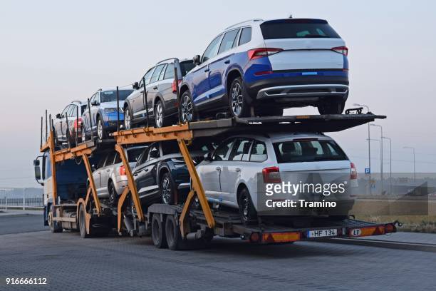 car transporter with skoda vehicles parked on the road - skoda auto stock pictures, royalty-free photos & images