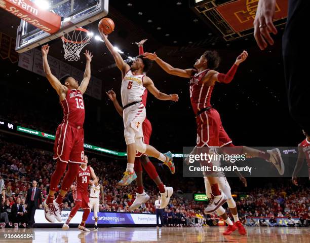 Lindell Wigginton of the Iowa State Cyclones lays up a shot as Jordan Shepherd, and Trae Young of the Oklahoma Sooners block in the first half of...
