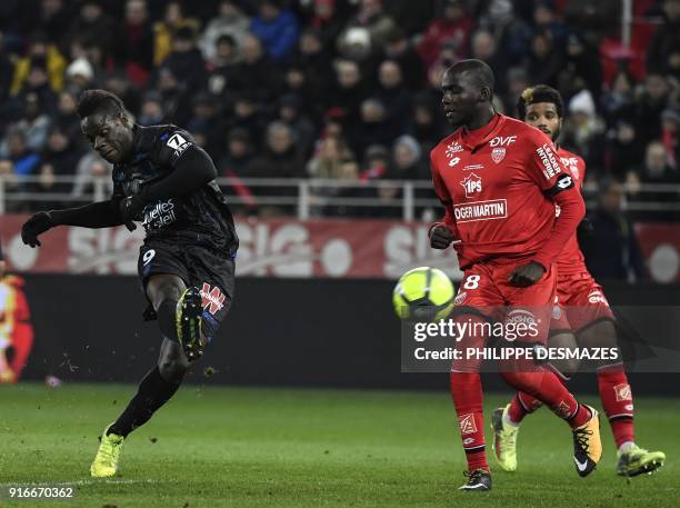 Nice's Italian forward Mario Balotelli vies with Dijon's French-Algerian midfielder Mehdi Abeid during the French L1 football match between Dijon FCO...