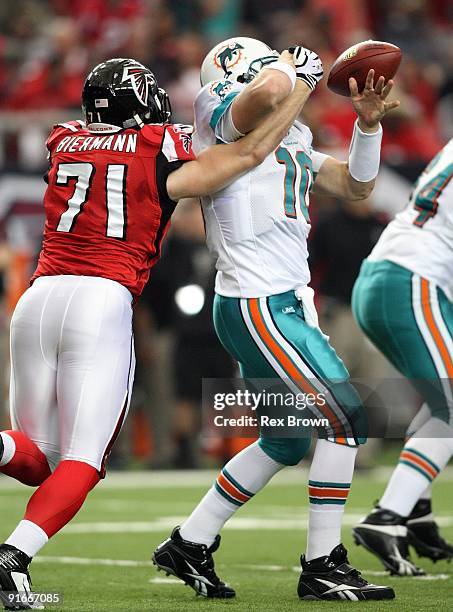 Chad Pennington the Miami Dolphins has the ball knocked out of his hands by Kroy Biermann the Atlanta Falcons at Georgia Dome on September 13, 2008...