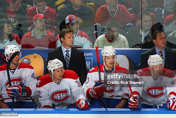 Assistant Coach Kirk Mueller and Head Coach Jacques Martin of the Montreal Canadiens look on from behind the bench during their NHL game against the...