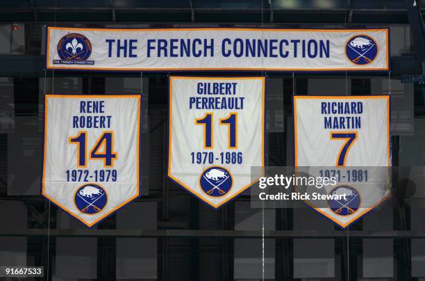 Banners of the numbers of the former Buffalo Sabres 'French Connection' line of Rene Robert, Gilbert Perreault and Richard Martin hang from the...