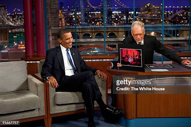 In this handout provide by the White House, U.S. President Barack Obama talks to TV Host David Letterman during a taping of "The Late Show with David...