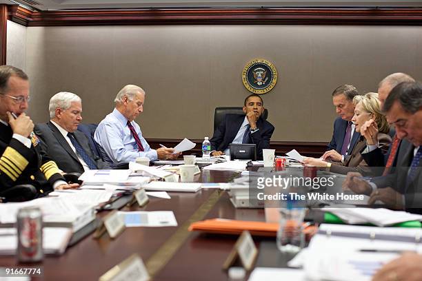 In this handout provide by the White House, U.S. President Barack Obama listens as his advisors Chairman of the Joint Chiefs of Staff Adm. Michael...
