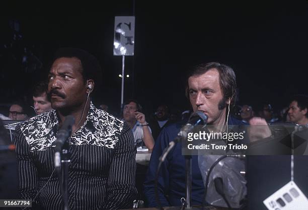 Heavyweight Title: View of former football player Jim Brown and English broadcaster David Frost watching Muhammad Ali vs George Foreman fight at 20th...
