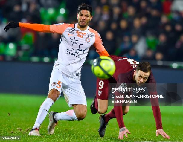 Metz' French forward Nolan Roux vies for the ball with Montpellier's Portuguese defender Pedro Mendes during the French L1 football match between...