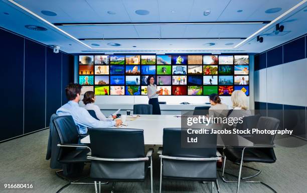 business people meeting in conference room with visual screen - meeting room screen stock-fotos und bilder