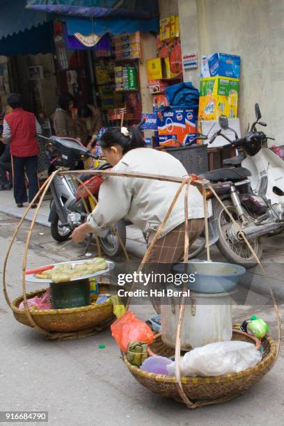 street food vendor carrying her whole restaurant in two baskets - carrying pole stock pictures, royalty-free photos & images