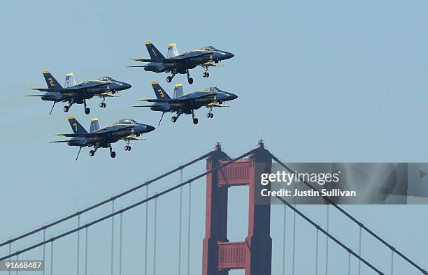 Navy Blue Angels F/A-18 Hornets pass over the Golden Gate Bridge during a practice performance ahead of the Fleet Week air show October 9, 2009 in...