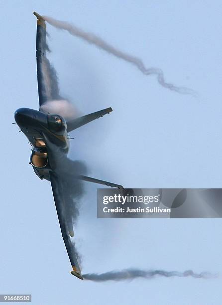 Vapor comes off the wings of a U.S. Navy Blue Angels F/A-18 Hornet during a practice performance ahead of the Fleet Week air show October 9, 2009 in...