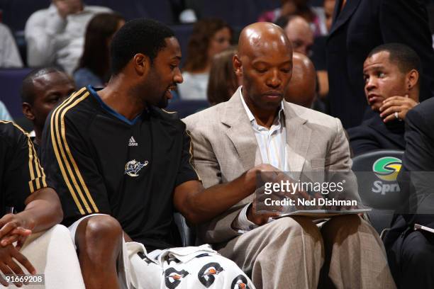 Gilbert Arenas and Assistant Coach Sam Cassell of the Washington Wizards discuss tactics against the Dallas Mavericks at the Verizon Center during a...