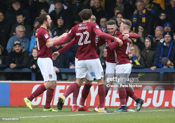 Matt Grimes of Northampton Town is congratulated by team mates after scoring his sides first goal from the penalty spot during the Sky Bet League One...