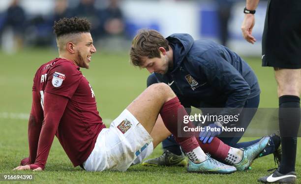 Daniel Powell of Northampton Town recieves treatment from physio Steve Bottom during the Sky Bet League One match between A.F.C. Wimbledon and...