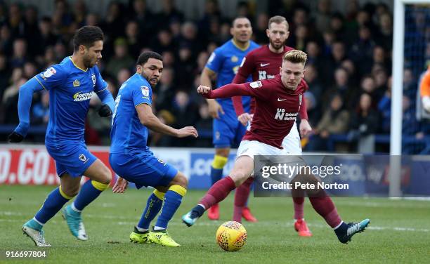 Sam Hoskins of Northampton Town looks to the ball with Harry Forrester and Andy Barcham of AFC Wimbledon during the Sky Bet League One match between...