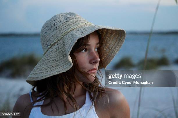 young girl at sunset on the beach - glaring meaning stock pictures, royalty-free photos & images