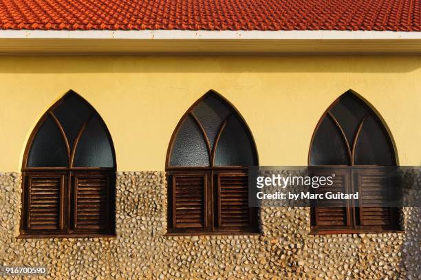 three windows on the side of alto vista chapel, aruba - noord amerika stock-fotos und bilder