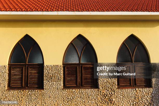 three windows on the side of alto vista chapel, aruba - windows vista stock pictures, royalty-free photos & images