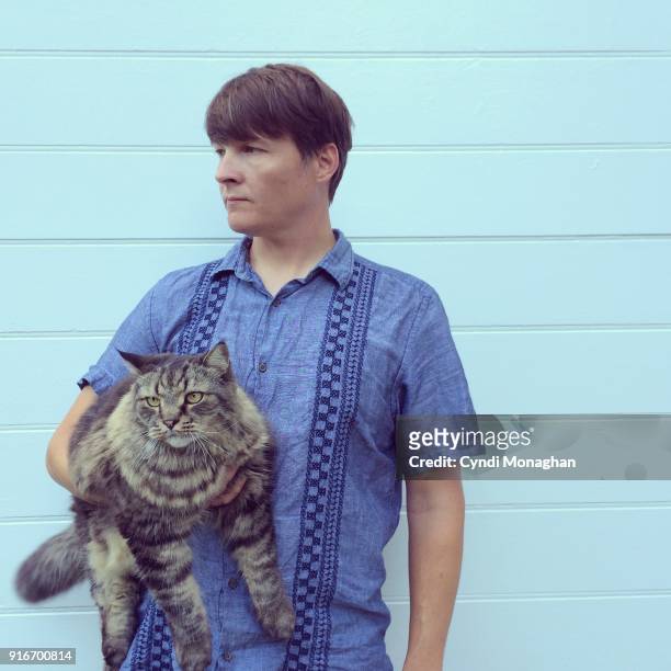 man holding a large cat - big cool attitude stock pictures, royalty-free photos & images