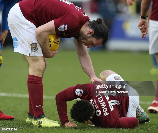 John-Joe O'Toole of Northampton Town aids team mate Daniel Poweel during the Sky Bet League One match between A.F.C. Wimbledon and Northampton Town...