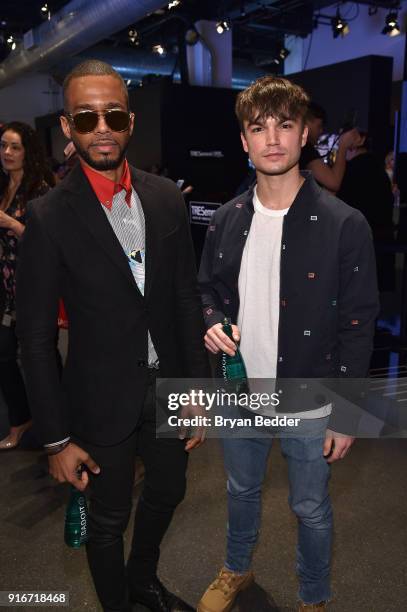 Actors Eric West and Samuel Mancini pose in front of the TRESemmé Salon at IMG NYFW: The Shows during IMG NYFW: The Shows at Spring Studios on...