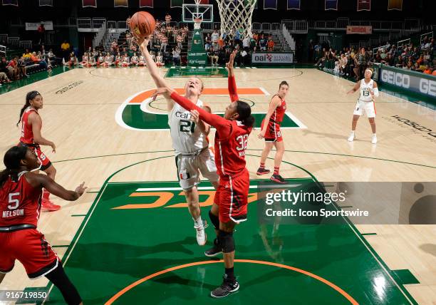 Miami forward/center Emese Hof shoots against NC State center Akela Maize during a women's college basketball game between the NC State University...