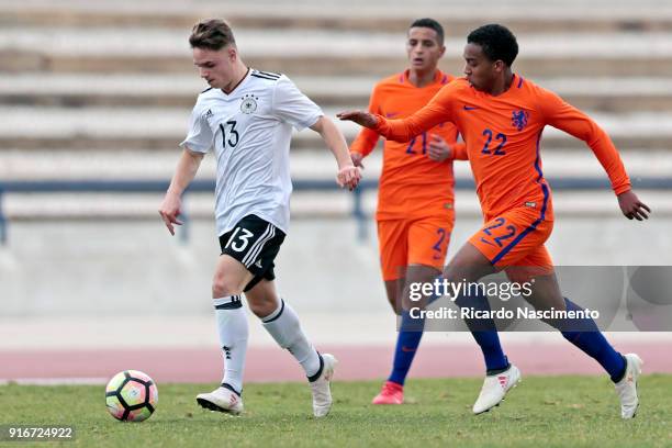 Robin Kolle of Germany U17 chalenges Mohamed Amine Ihattaren and Quinten Maduro of Netherlands U17 during U17-Juniors Algarve Cup match between U17...