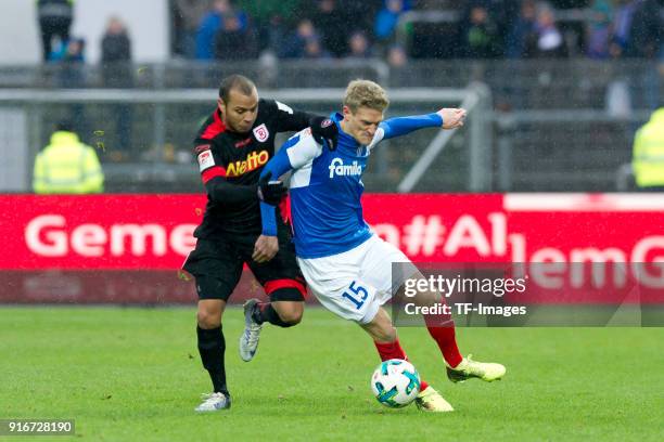 Jann George of Regensburg and Johannes van den Bergh of Kiel battle for the ball during the Second Bundesliga match between Holstein Kiel and SSV...