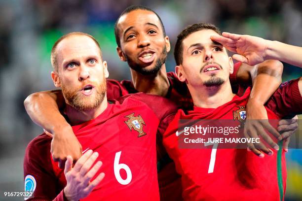 Portugal's Pedro Cary, Nilson Miguela and Bruno Coelho celebrate after scoring a goal during the European Futsal Championship final match between...