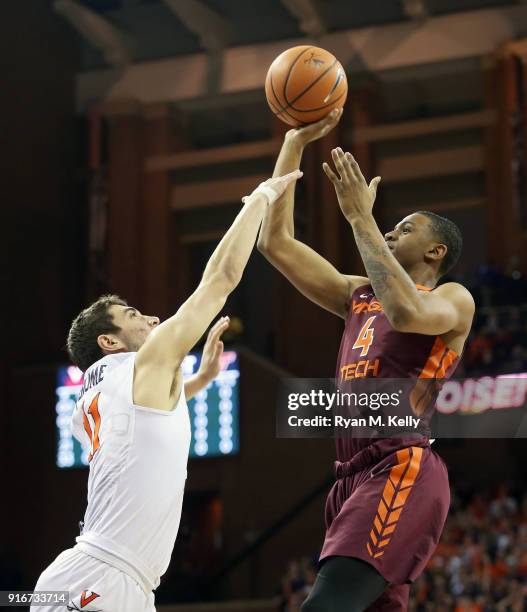 Nickeil Alexander-Walker of the Virginia Tech Hokies shoots over Ty Jerome of the Virginia Cavaliers in the first half during a game at John Paul...