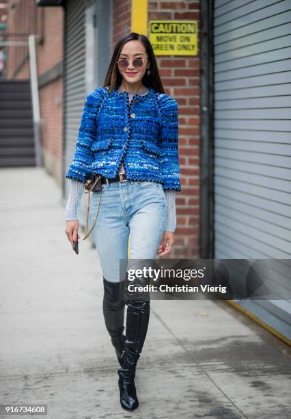 Chriselle Lim wearing denim jeans, overknees boots seen outside Self-Portrait on February 10, 2018 in New York City.