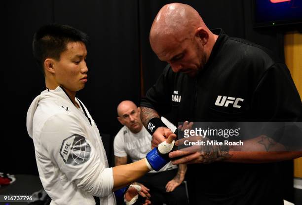 Ben Nguyen puts on his gloves backstage during the UFC 221 event at Perth Arena on February 11, 2018 in Perth, Australia.