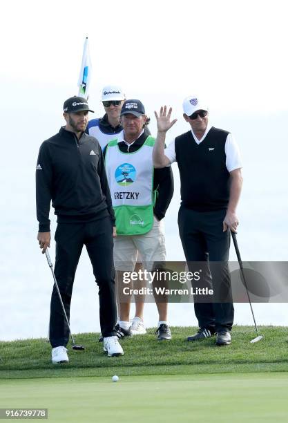 Dustin Johnson and Wayne Gretzky stand on the 18th green during Round Three of the AT&T Pebble Beach Pro-Am at Spyglass Hill Golf Course on February...