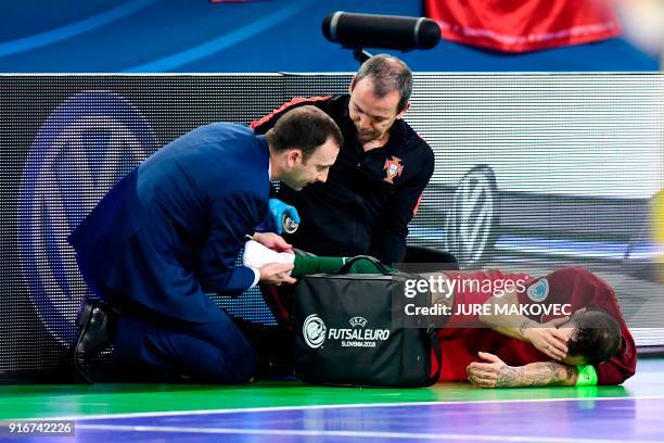 Portugals Ricardinho lies injured on the floor during the European Futsal Championship final match between Portugal and Spain at Arena Stozice in...