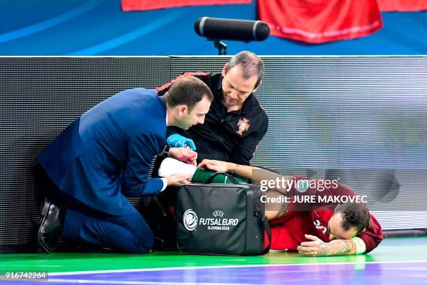 Portugals Ricardinho lies injured on the floor during the European Futsal Championship final match between Portugal and Spain at Arena Stozice in...