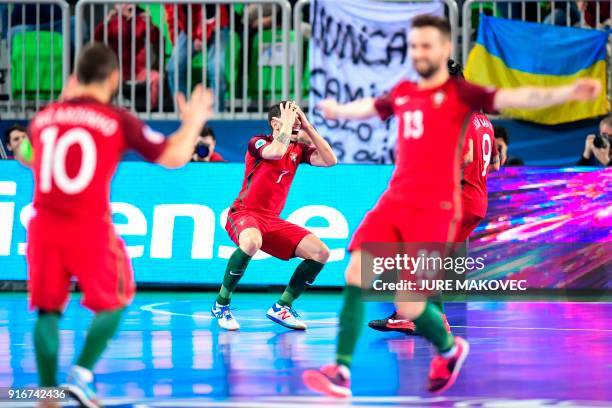 Portugals players celebrate after scoring a goal during the European Futsal Championship final match between Portugal and Spain at Arena Stozice in...