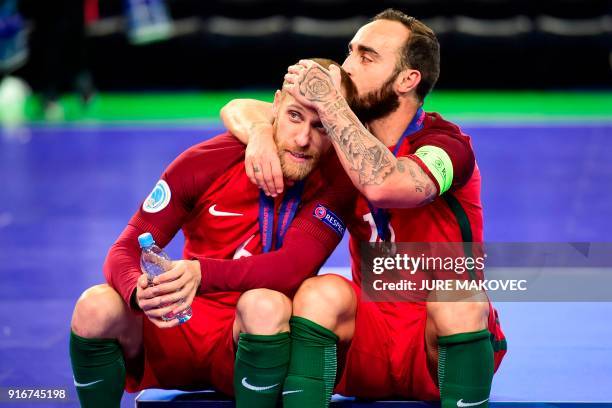 Portugals Pedro Cary and Ricardinho react after winning the European Futsal Championship at Arena Stozice in Ljubljana, Slovenia on February 10,...