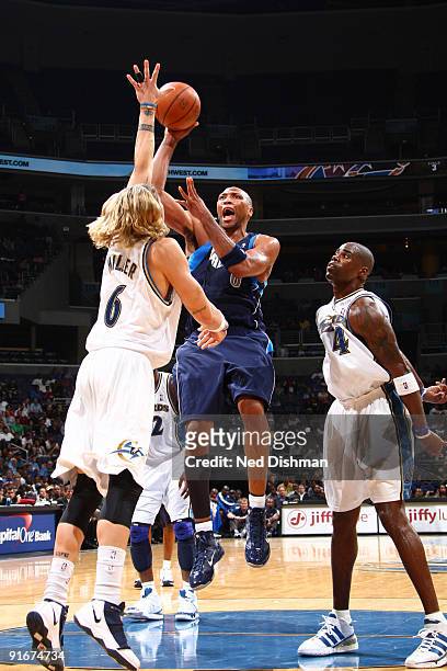 Shawn Marion of the Dallas Mavericks shoots against Mike Miller of the Washington Wizards at the Verizon Center during a preseason game on October 9,...
