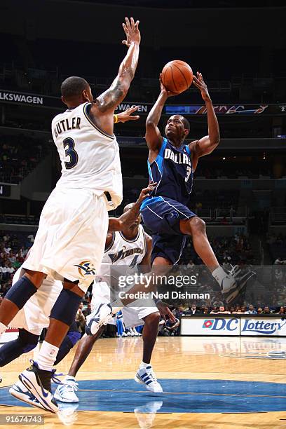 Rodrique Beaubois of the Dallas Mavericks shoots against Caron Butler of the Washington Wizards at the Verizon Center during a preseason game on...