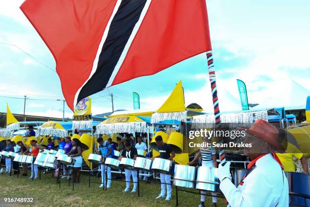 Peter Diaz holds the national flag while members of the Arima Angel Harps Steel Orchetsra rehearse before the Panorama Finals in the Queen's Park...