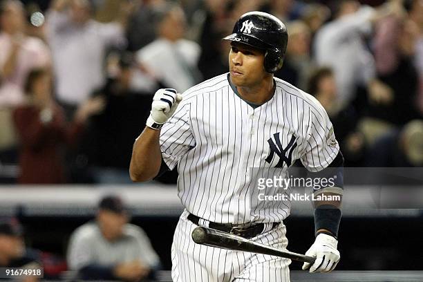 Alex Rodriguez of the New York Yankees celebrates after hitting a two run home run in the ninth inning against the Minnesota Twins in Game Two of the...