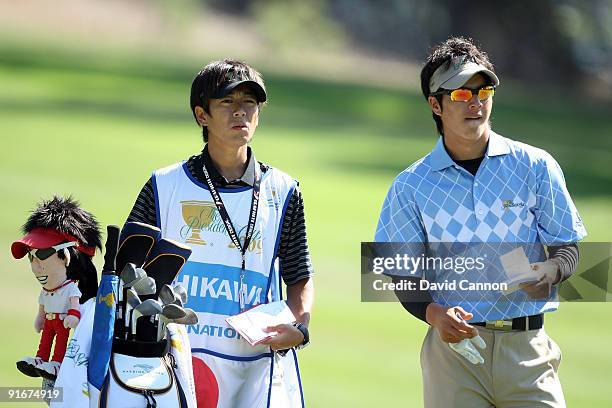 Ryo Ishikawa of Japan and the International Team prepares to hit his second shot at the 7th hole during the Day Two Fourball Matches in The...